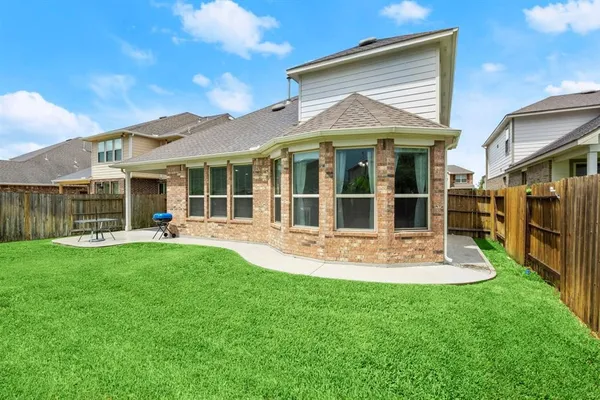 a view of a house with a yard and sitting area