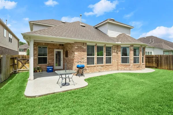 a view of a house with a yard porch and furniture
