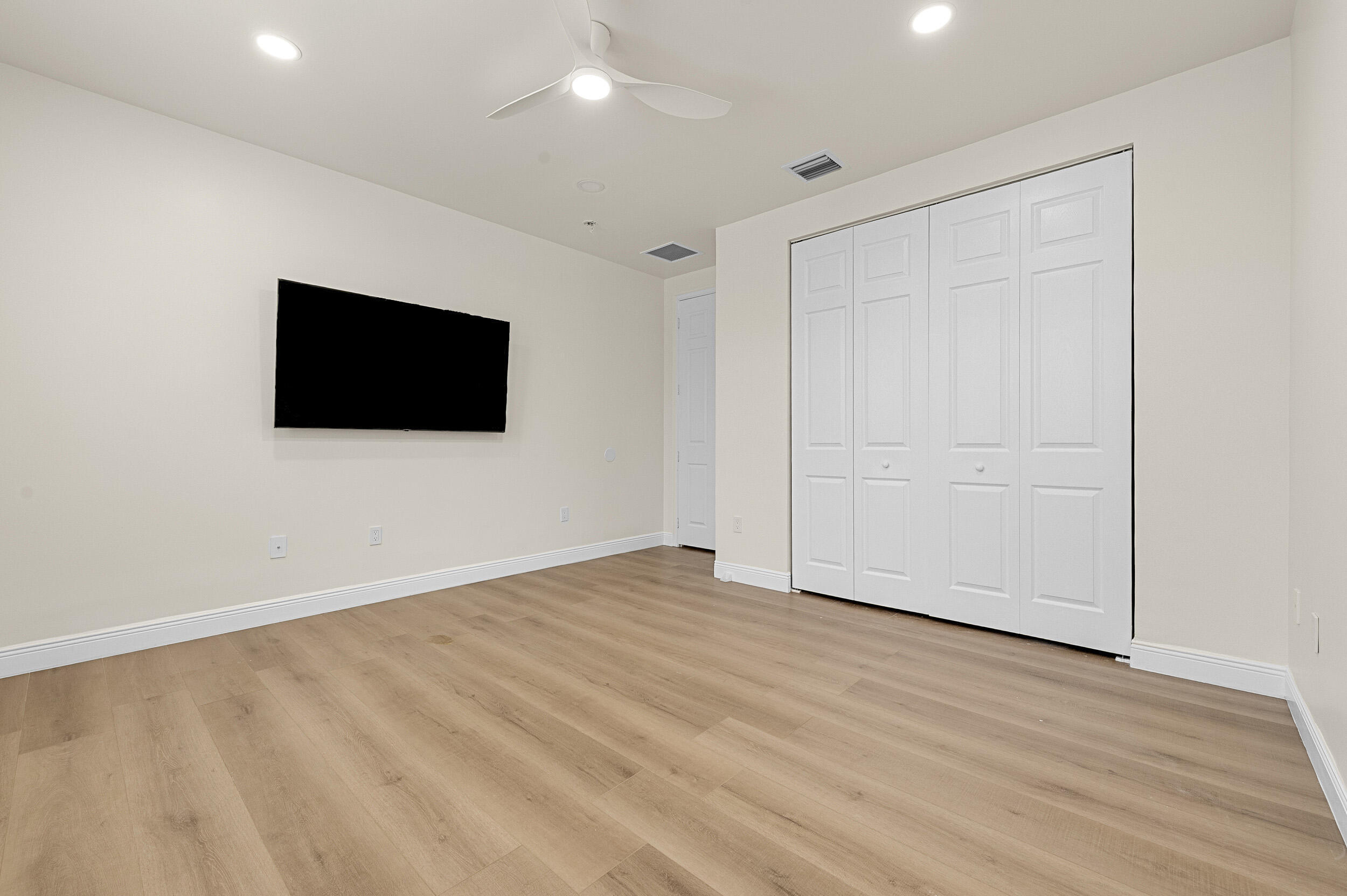 8680 Daystar Ridge Point Boynton Beach, FL 33473 - Photo 12 of 25 a view of an empty room with wooden floor and a window