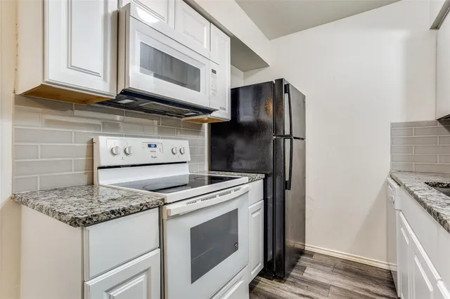 a view of room with window and wooden floor