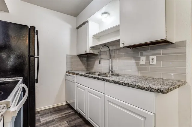 a kitchen with stainless steel appliances granite countertop a sink stove and cabinets