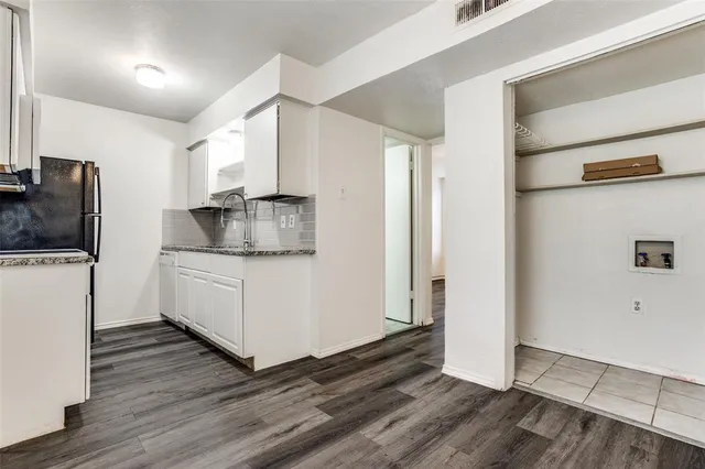 a kitchen with granite countertop a sink and a stove