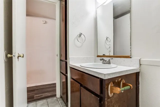 a kitchen with stainless steel appliances white cabinets and wooden floors