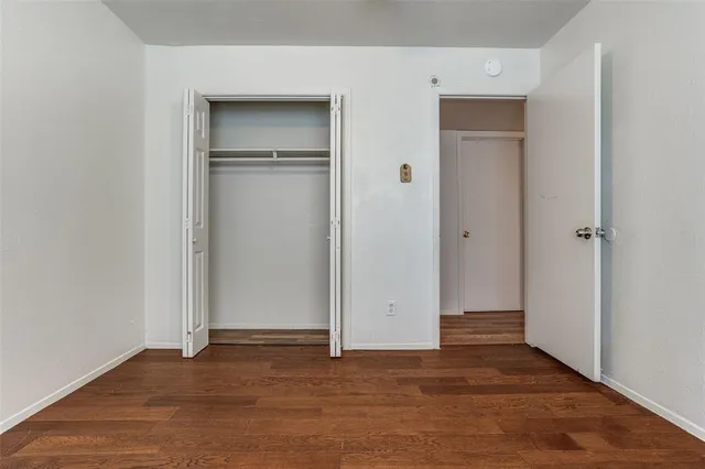 an empty room with closet area
