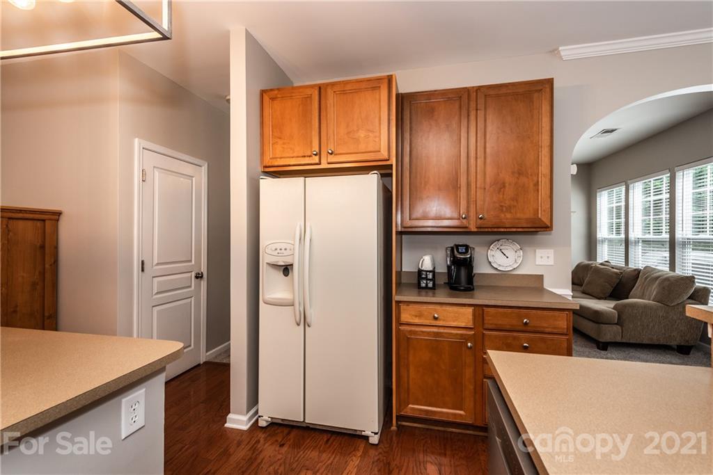 151 Whitley Mills Road Fort Mill, SC 29708 - Photo 12 of 33 a kitchen with stainless steel appliances granite countertop a refrigerator a stove and a sink with wooden floor