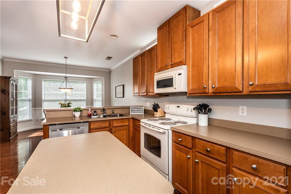 151 Whitley Mills Road Fort Mill, SC 29708 - Photo 13 of 33 a kitchen with stainless steel appliances a stove sink microwave and cabinets