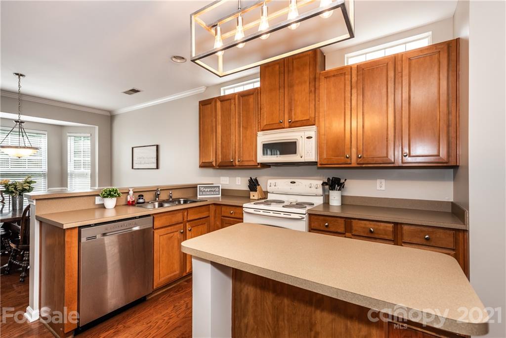 151 Whitley Mills Road Fort Mill, SC 29708 - Photo 14 of 33 a kitchen with stainless steel appliances a sink a stove a microwave a sink and cabinets