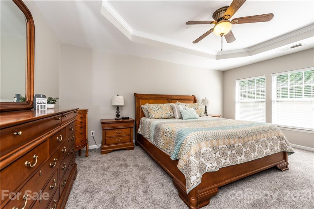 151 Whitley Mills Road Fort Mill, SC 29708 - Photo 17 of 33 a bedroom with a bed and a chandelier