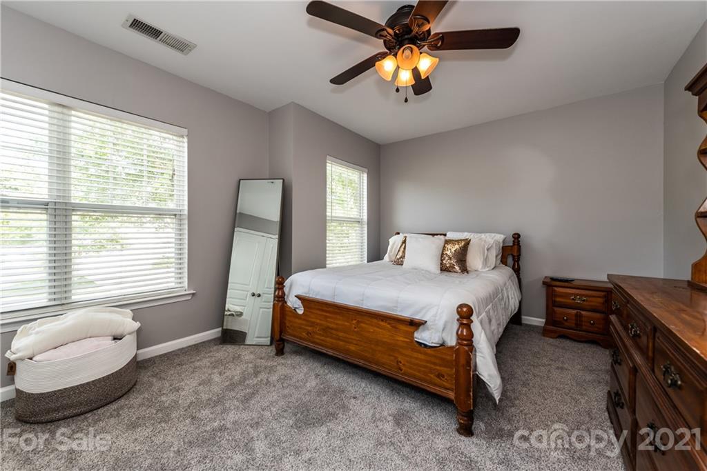 151 Whitley Mills Road Fort Mill, SC 29708 - Photo 26 of 33 a bedroom with a bed and a chandelier