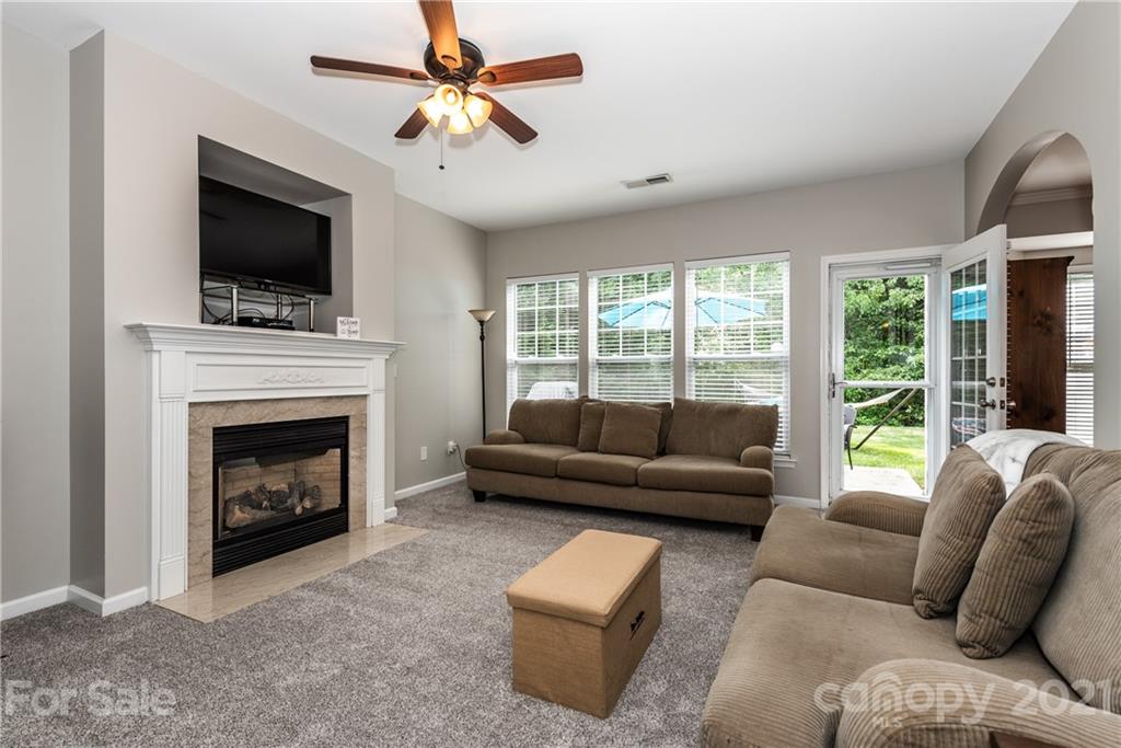 151 Whitley Mills Road Fort Mill, SC 29708 - Photo 5 of 33 a living room with furniture a flat screen tv and a fireplace