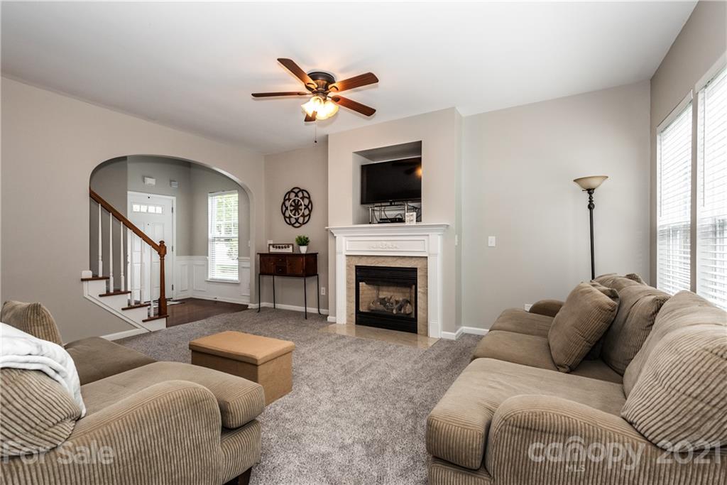 151 Whitley Mills Road Fort Mill, SC 29708 - Photo 6 of 33 a living room with furniture a fireplace and a flat screen tv