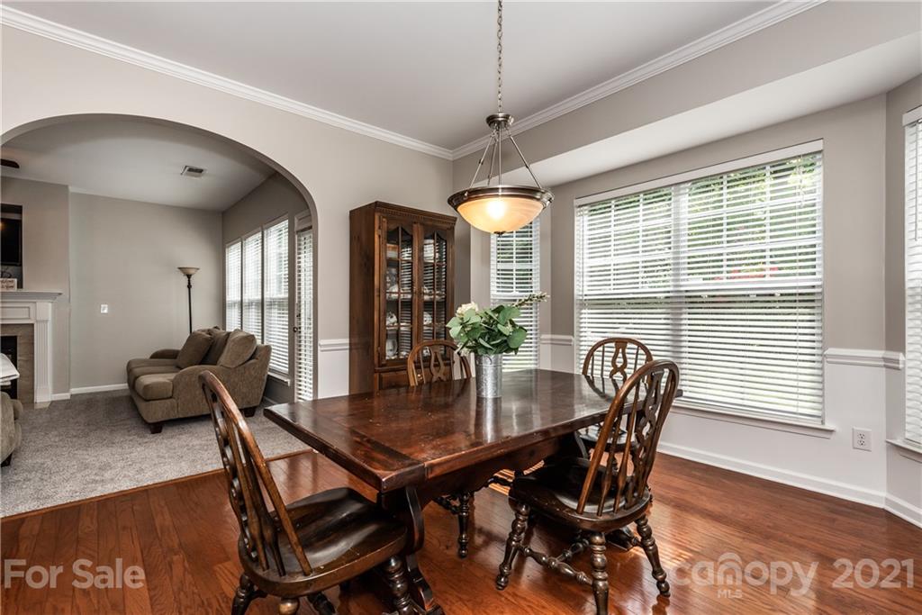 151 Whitley Mills Road Fort Mill, SC 29708 - Photo 9 of 33 a view of a dining room with furniture window and wooden floor
