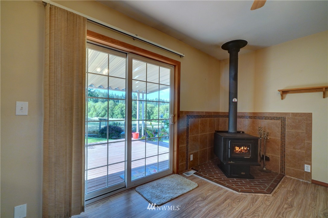 9116 Johnson Road Anderson Island, WA 98303 - Photo 14 of 40 a view of an empty room with wooden floor and a window