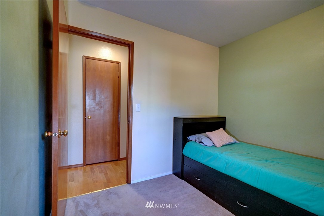 9116 Johnson Road Anderson Island, WA 98303 - Photo 22 of 40 a bedroom with a bed and a dresser