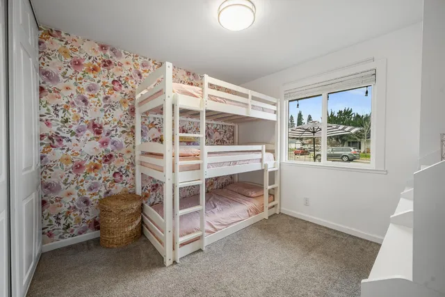a bedroom with a large bed and a potted plant