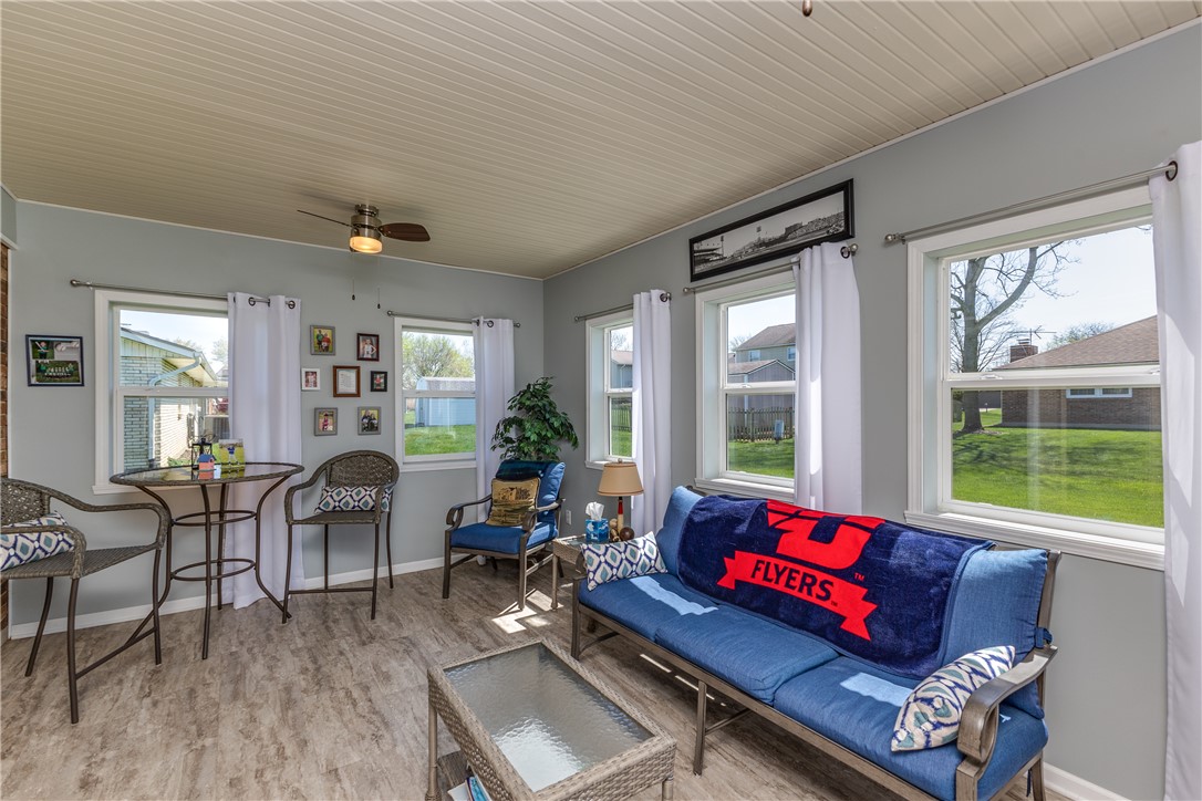 4210 Pleasanton Road Englewood, OH 45322 - Photo 15 of 34 This bright sunroom features multiple windows and durable flooring, perfect for relaxed living.
