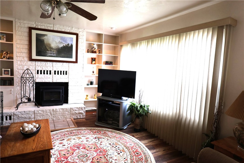 1409 North Street Corning, CA 96021 - Photo 11 of 40 a living room with furniture a flat screen tv and a fireplace