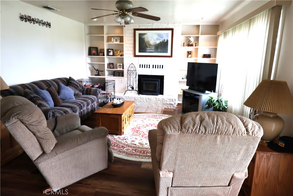 1409 North Street Corning, CA 96021 - Photo 13 of 40 a living room with furniture a flat screen tv and a fireplace