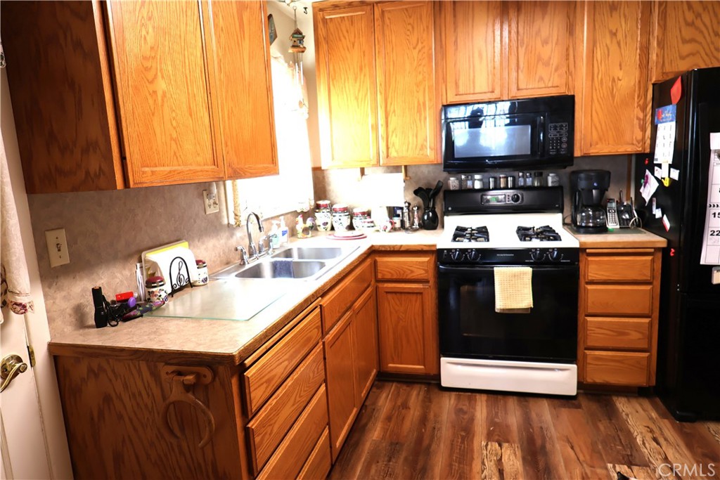 1409 North Street Corning, CA 96021 - Photo 17 of 40 a kitchen with stainless steel appliances a stove a sink and a microwave