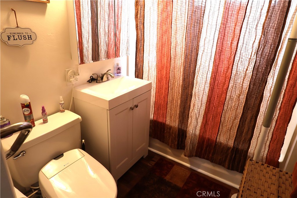 1409 North Street Corning, CA 96021 - Photo 24 of 40 a bathroom with a sink toilet and window