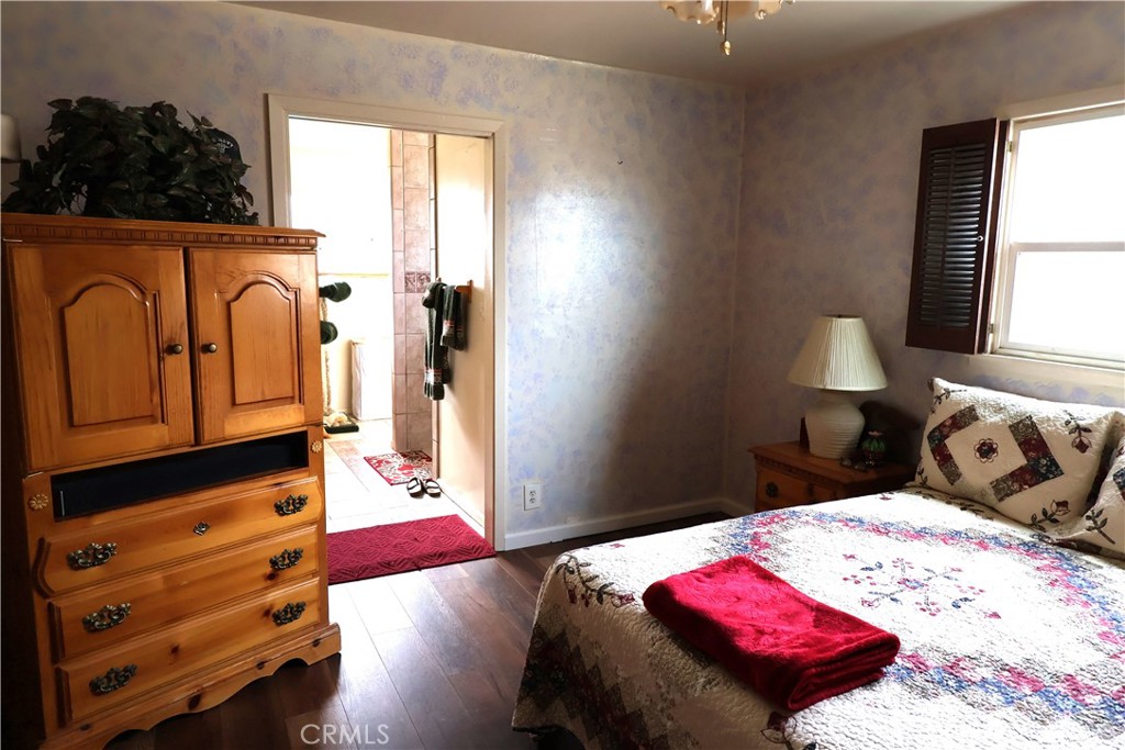 1409 North Street Corning, CA 96021 - Photo 33 of 40 a bedroom with a bed and dresser with mirror