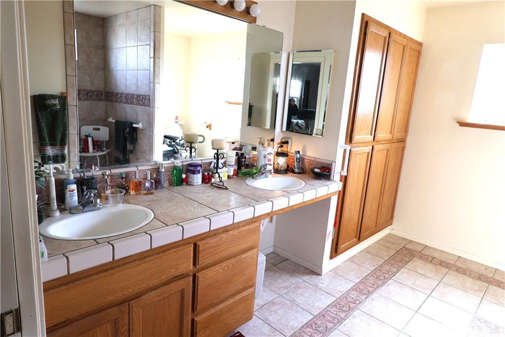 1409 North Street Corning, CA 96021 - Photo 38 of 40 a bathroom with a sink and a mirror