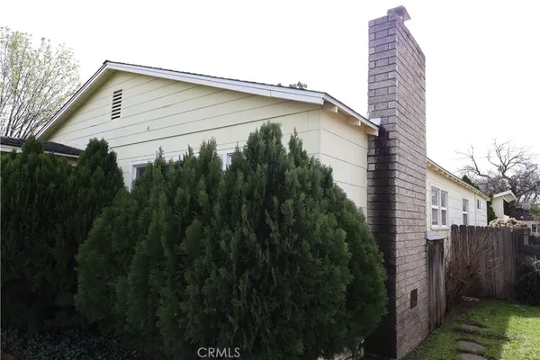 a blue house with trees in front of it
