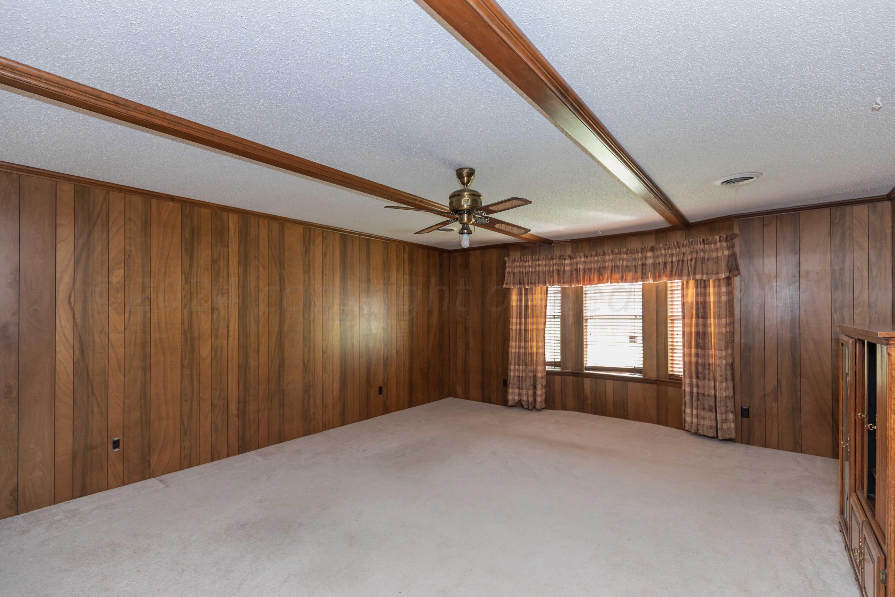 4400 Gem Lake Road Amarillo, TX 79106 - Photo 15 of 57 a view of a livingroom with a ceiling fan and window