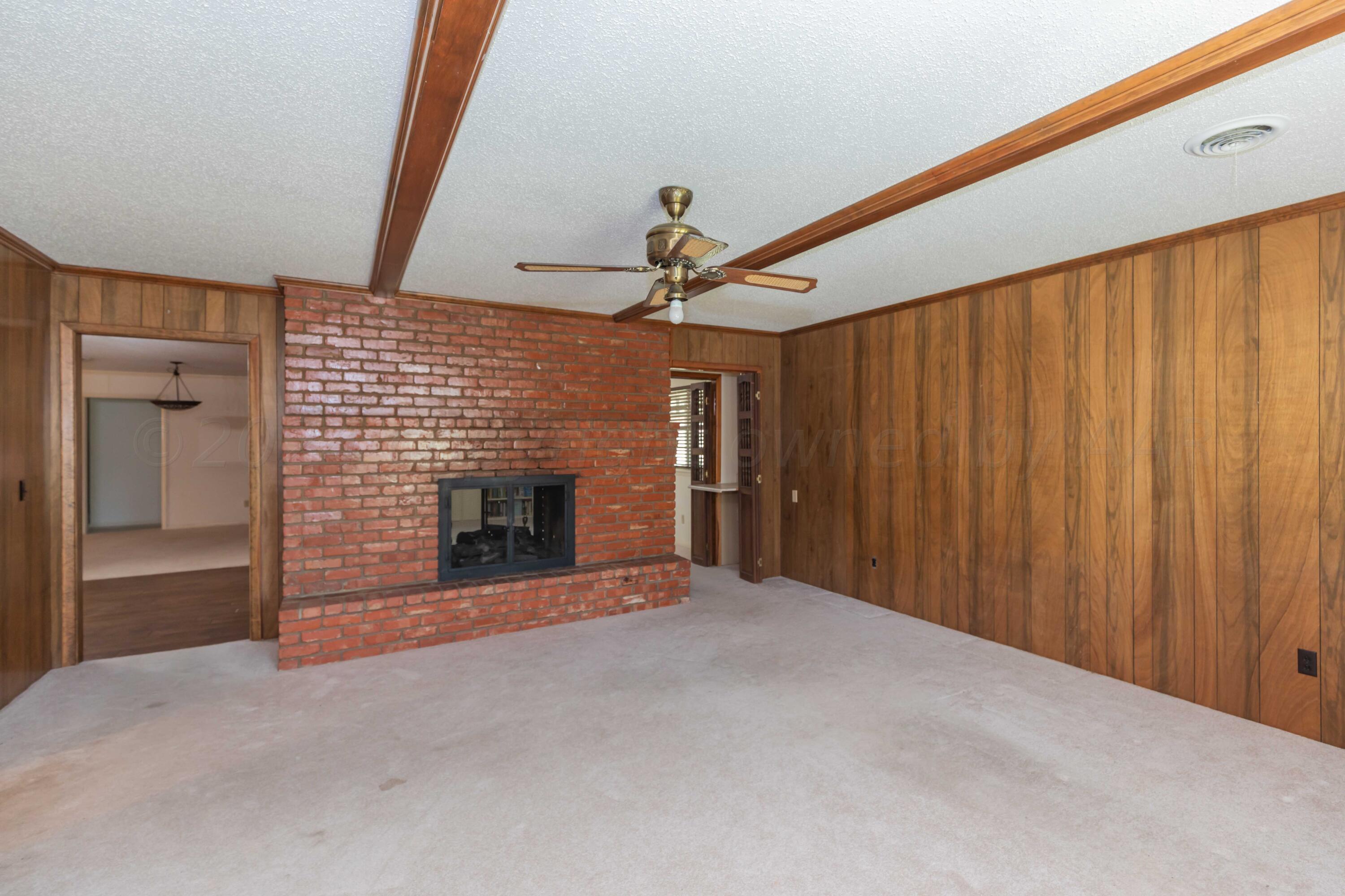 4400 Gem Lake Road Amarillo, TX 79106 - Photo 16 of 57 a view of an empty room with a fireplace and a window