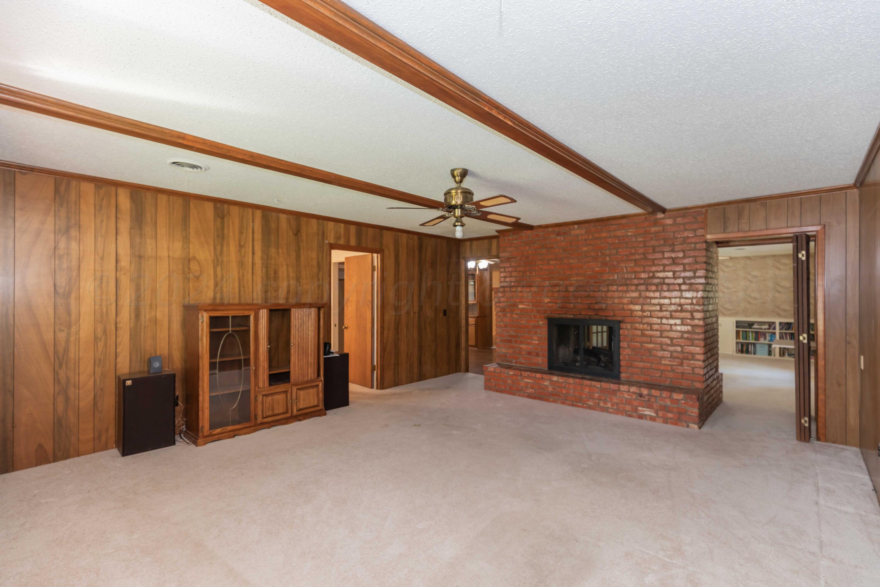 4400 Gem Lake Road Amarillo, TX 79106 - Photo 17 of 57 a view of an empty room with a fireplace