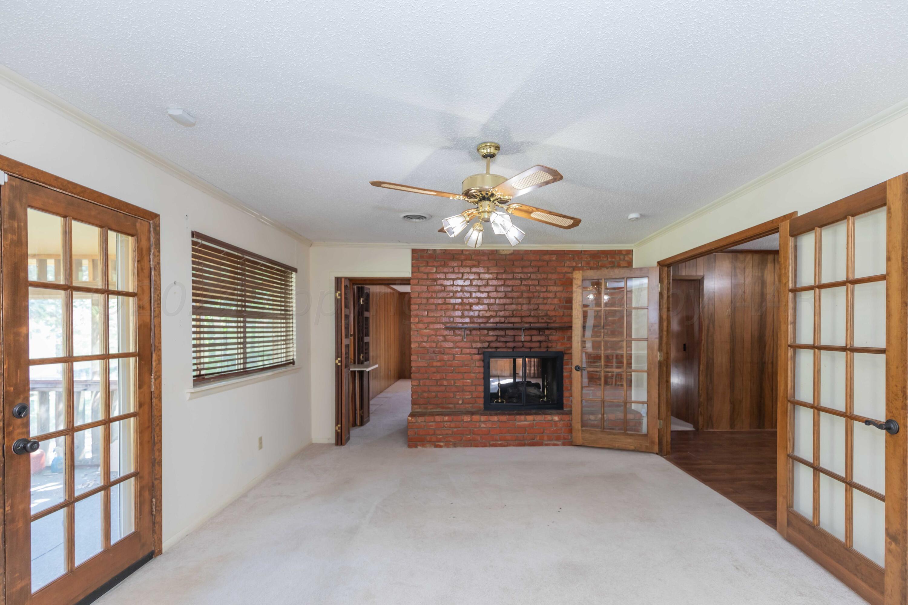 4400 Gem Lake Road Amarillo, TX 79106 - Photo 20 of 57 an empty room with windows and fireplace