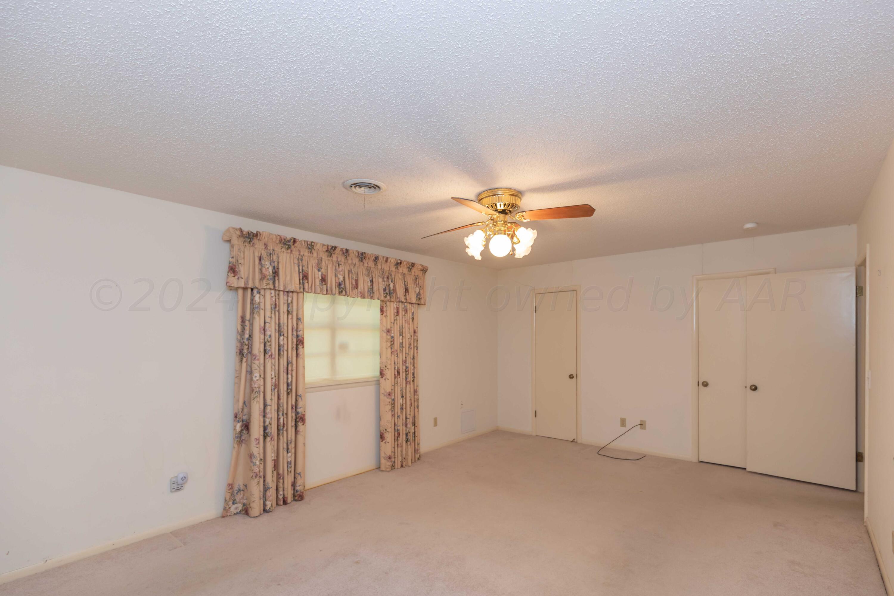 4400 Gem Lake Road Amarillo, TX 79106 - Photo 22 of 57 an empty room with windows and fan