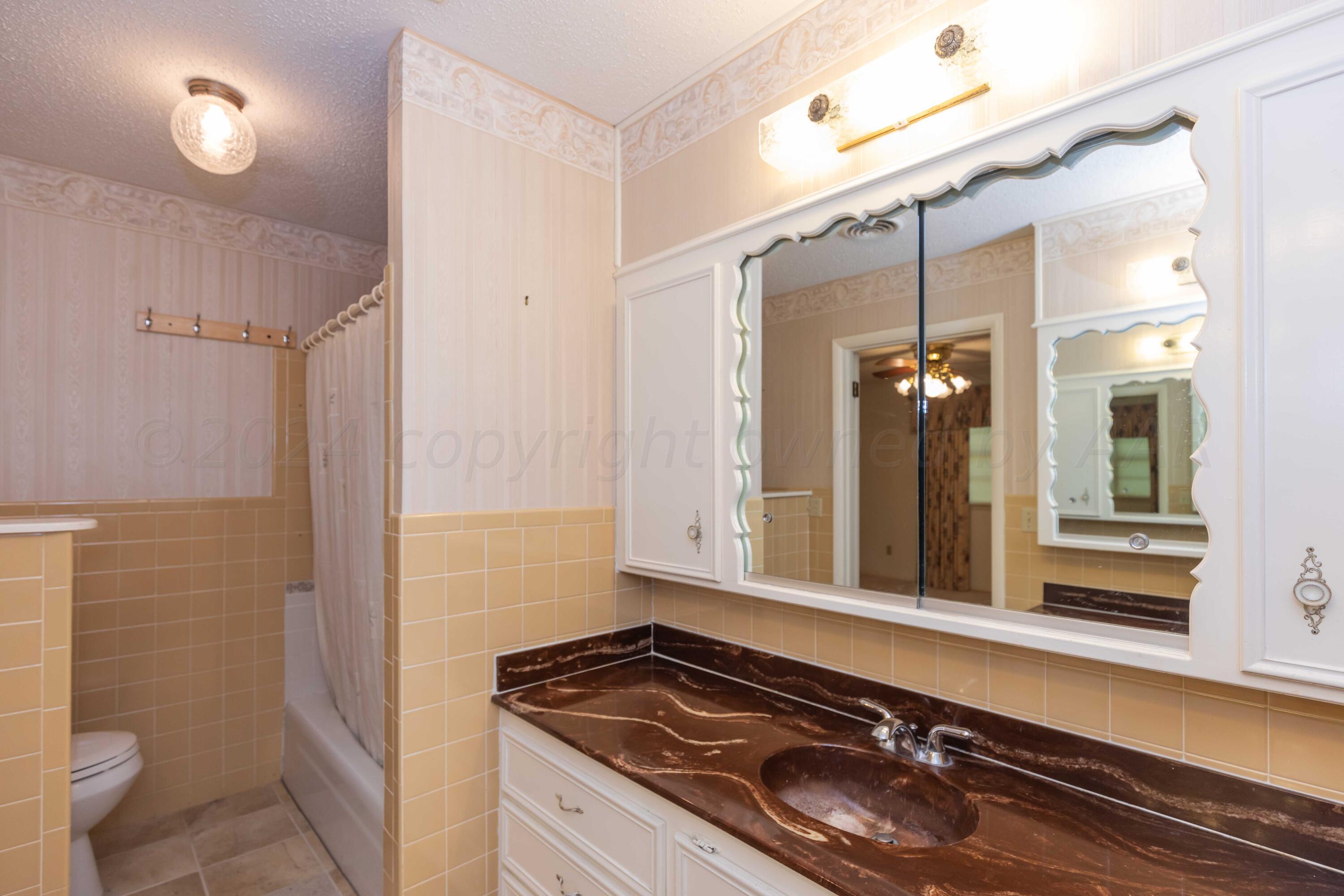 4400 Gem Lake Road Amarillo, TX 79106 - Photo 25 of 57 a bathroom with a sink and a mirror
