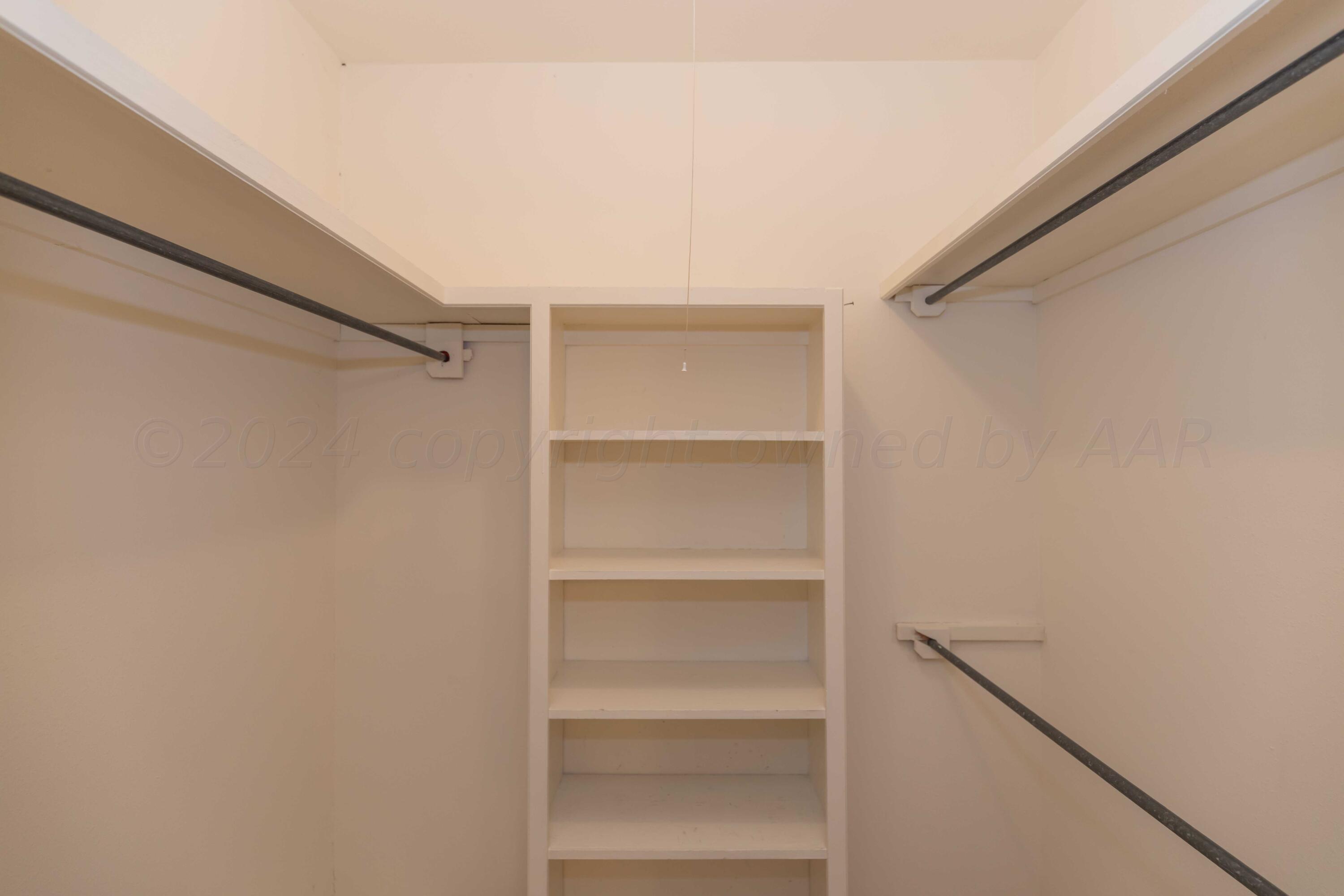 4400 Gem Lake Road Amarillo, TX 79106 - Photo 26 of 57 a view of walk in closet with empty racks