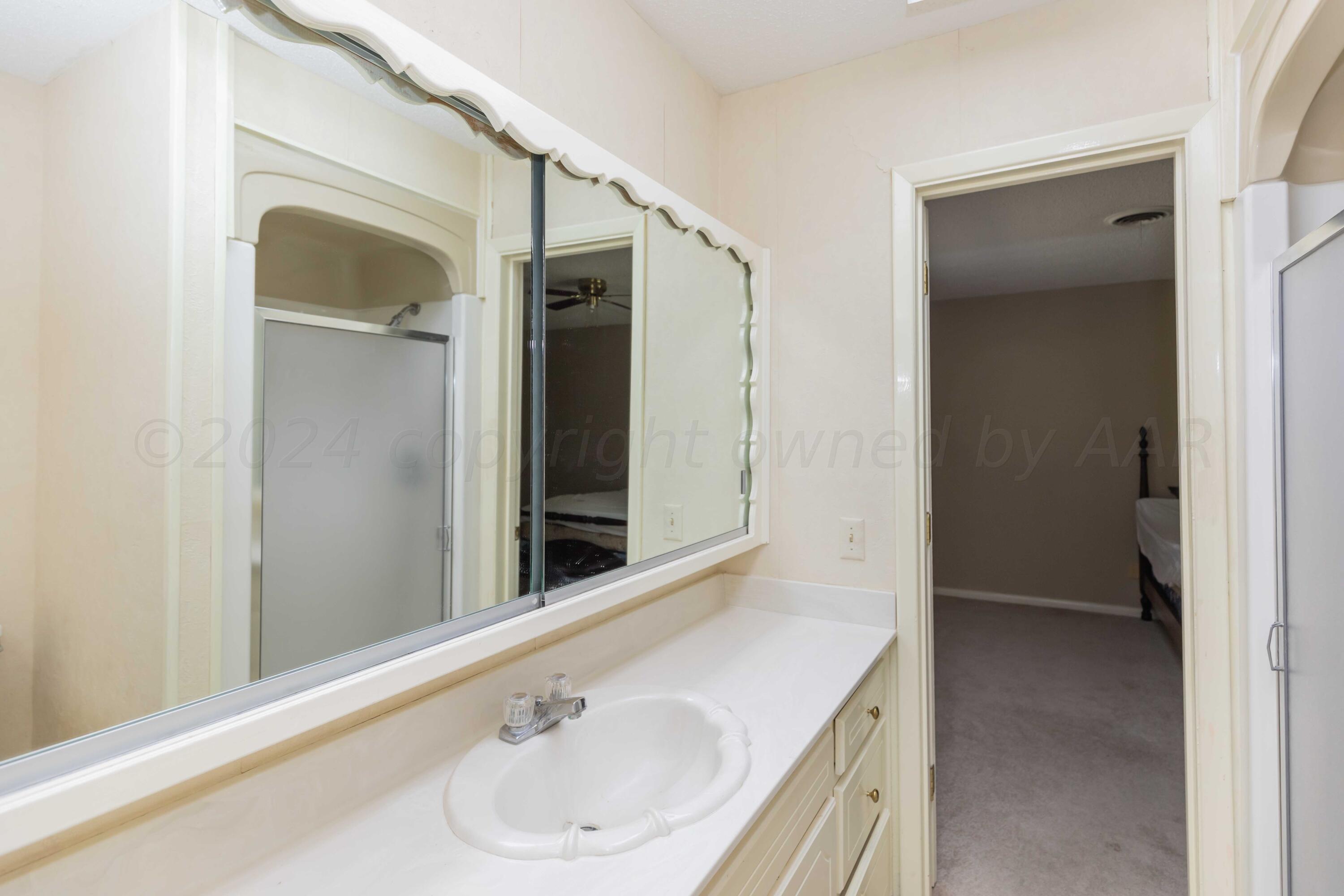 4400 Gem Lake Road Amarillo, TX 79106 - Photo 30 of 57 a bathroom with a sink and a mirror