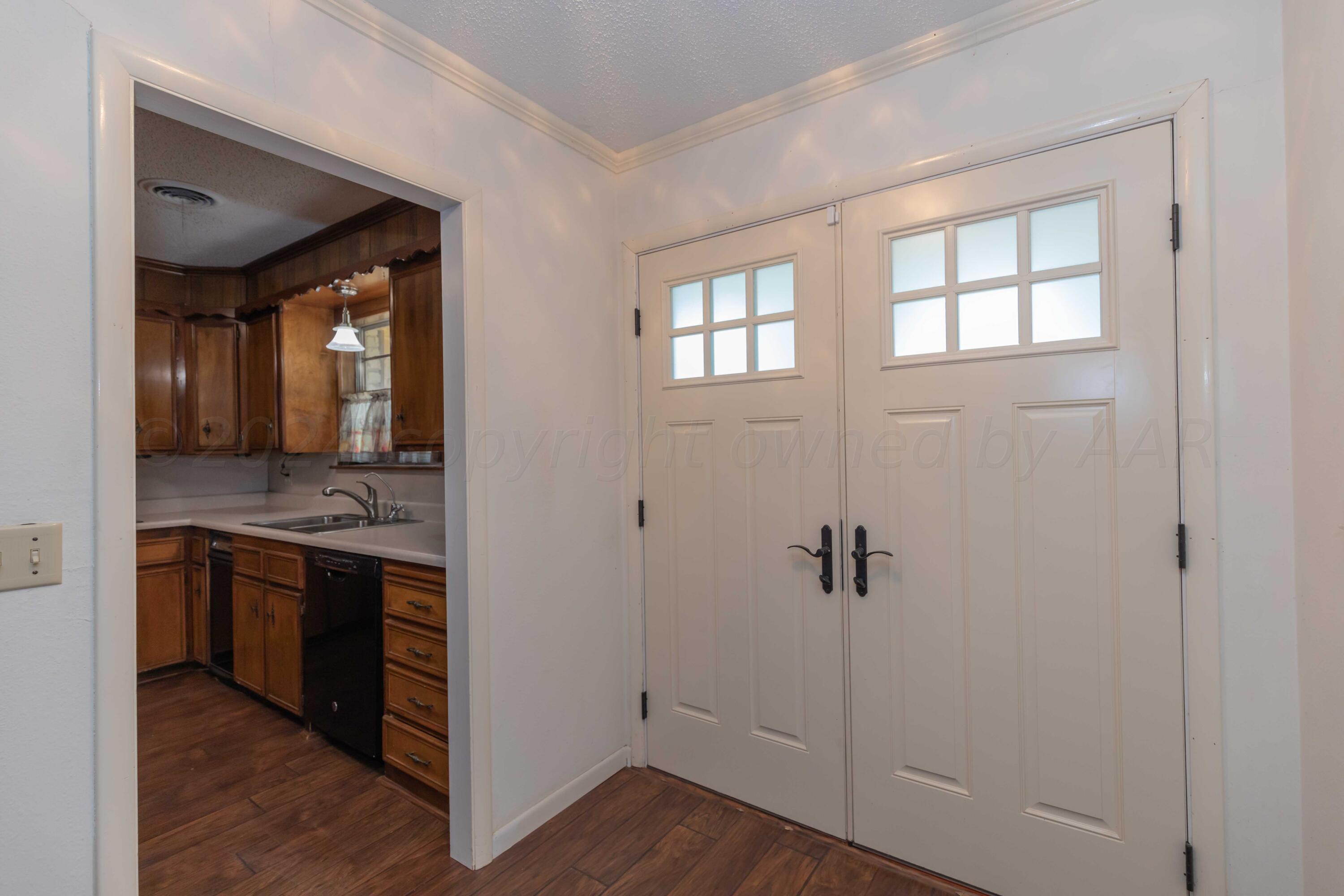 4400 Gem Lake Road Amarillo, TX 79106 - Photo 3 of 57 a view of a kitchen from the hallway