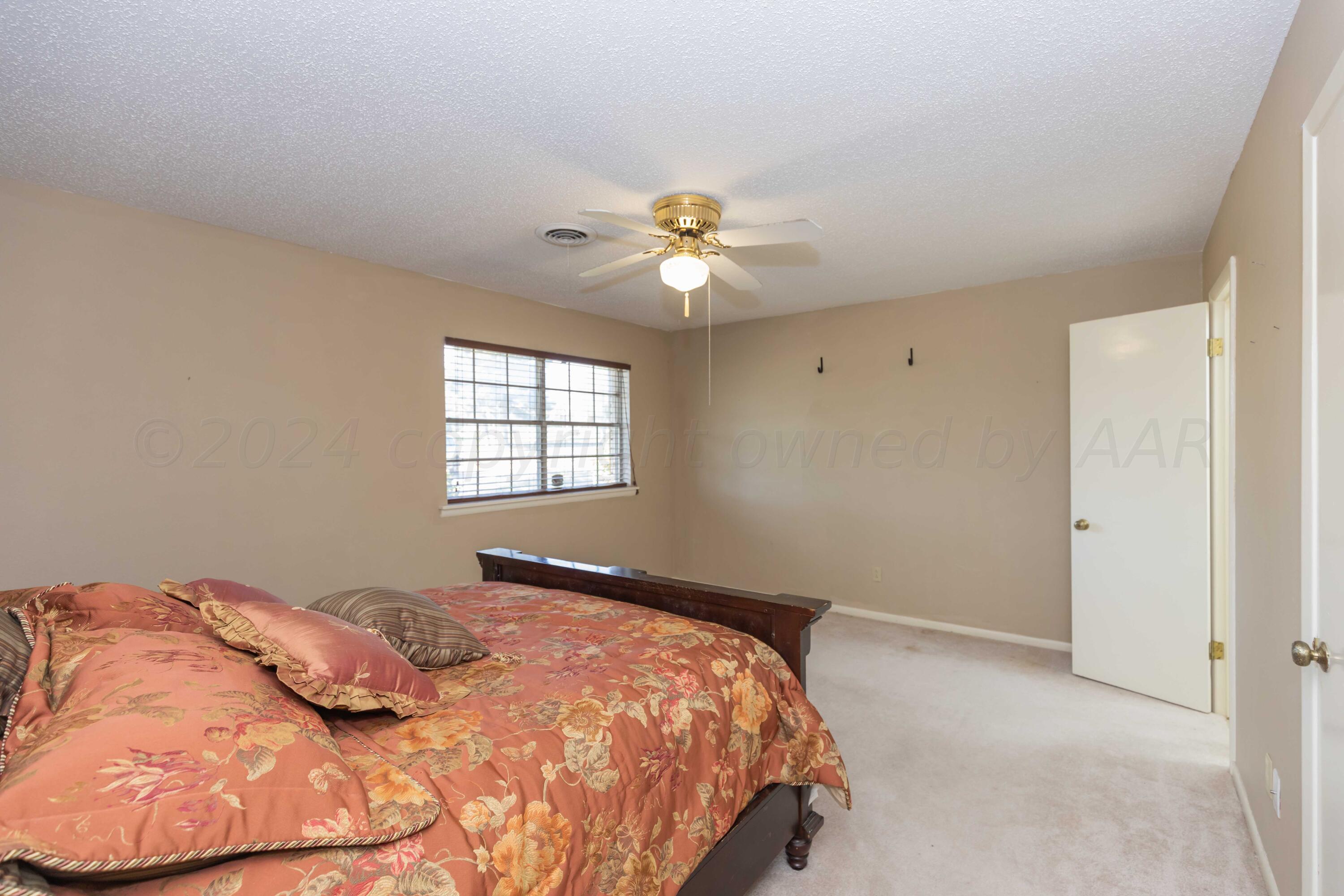 4400 Gem Lake Road Amarillo, TX 79106 - Photo 32 of 57 a bedroom with a bed and a ceiling fan