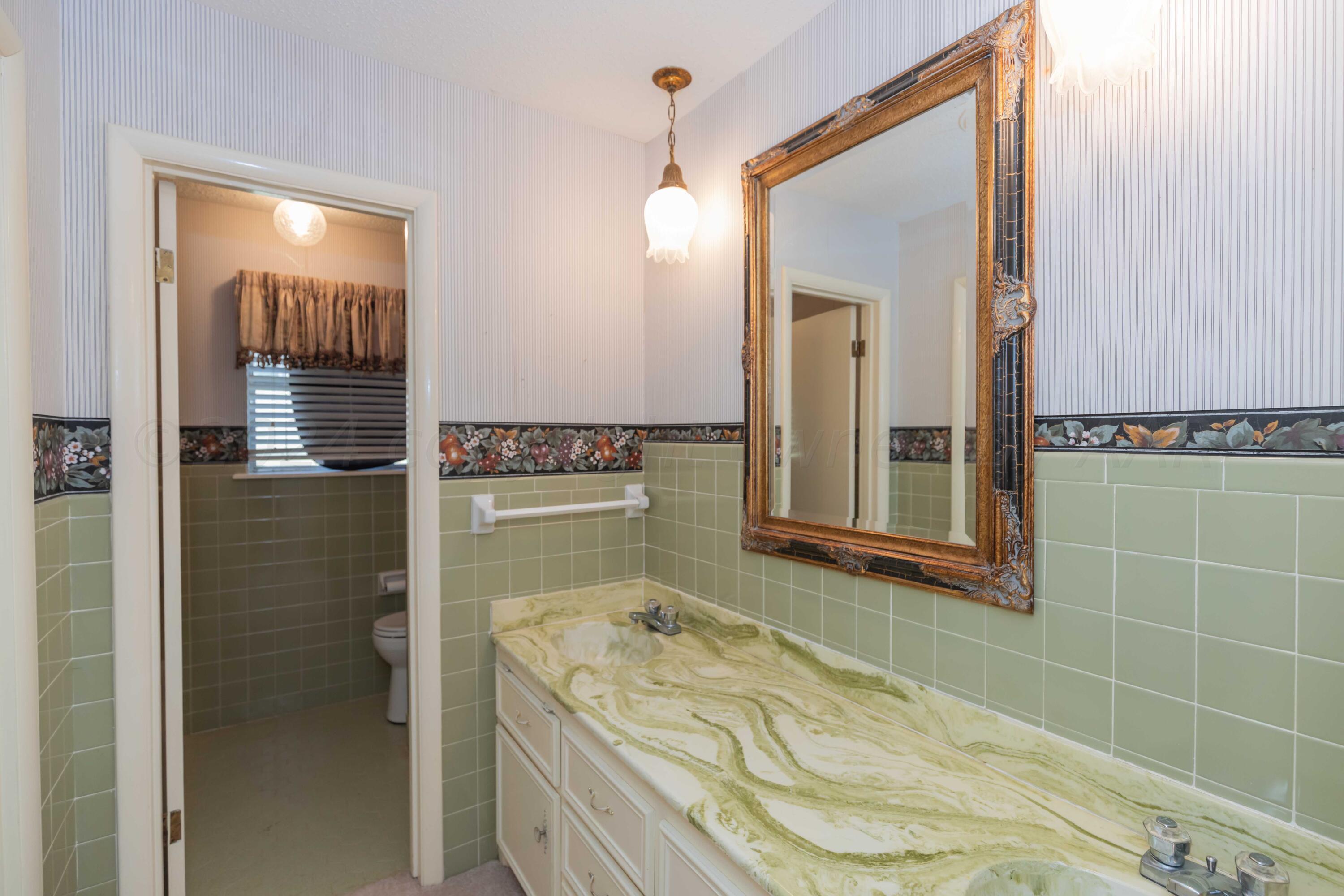 4400 Gem Lake Road Amarillo, TX 79106 - Photo 34 of 57 a bathroom with a tub a sink and a mirror