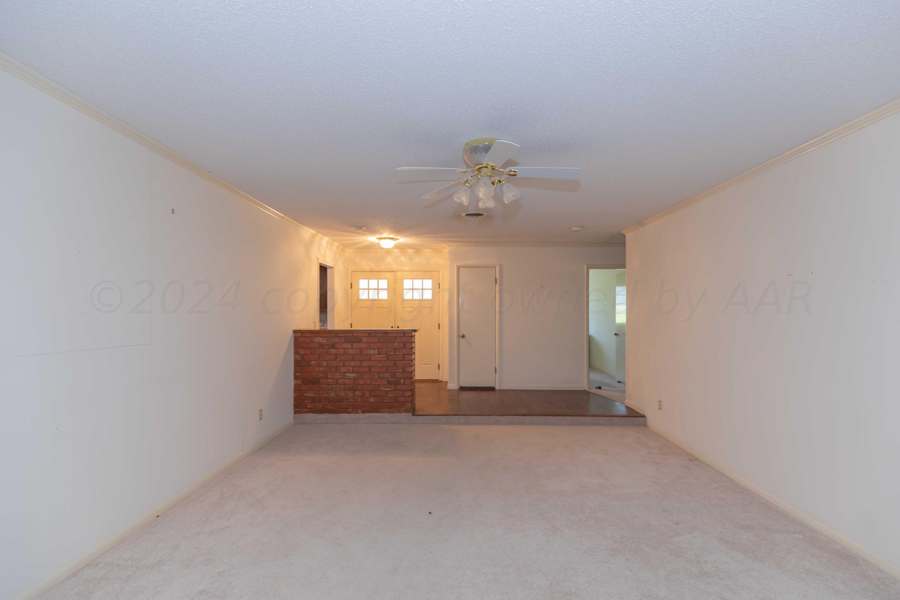 4400 Gem Lake Road Amarillo, TX 79106 - Photo 5 of 57 an empty room with windows and entrance
