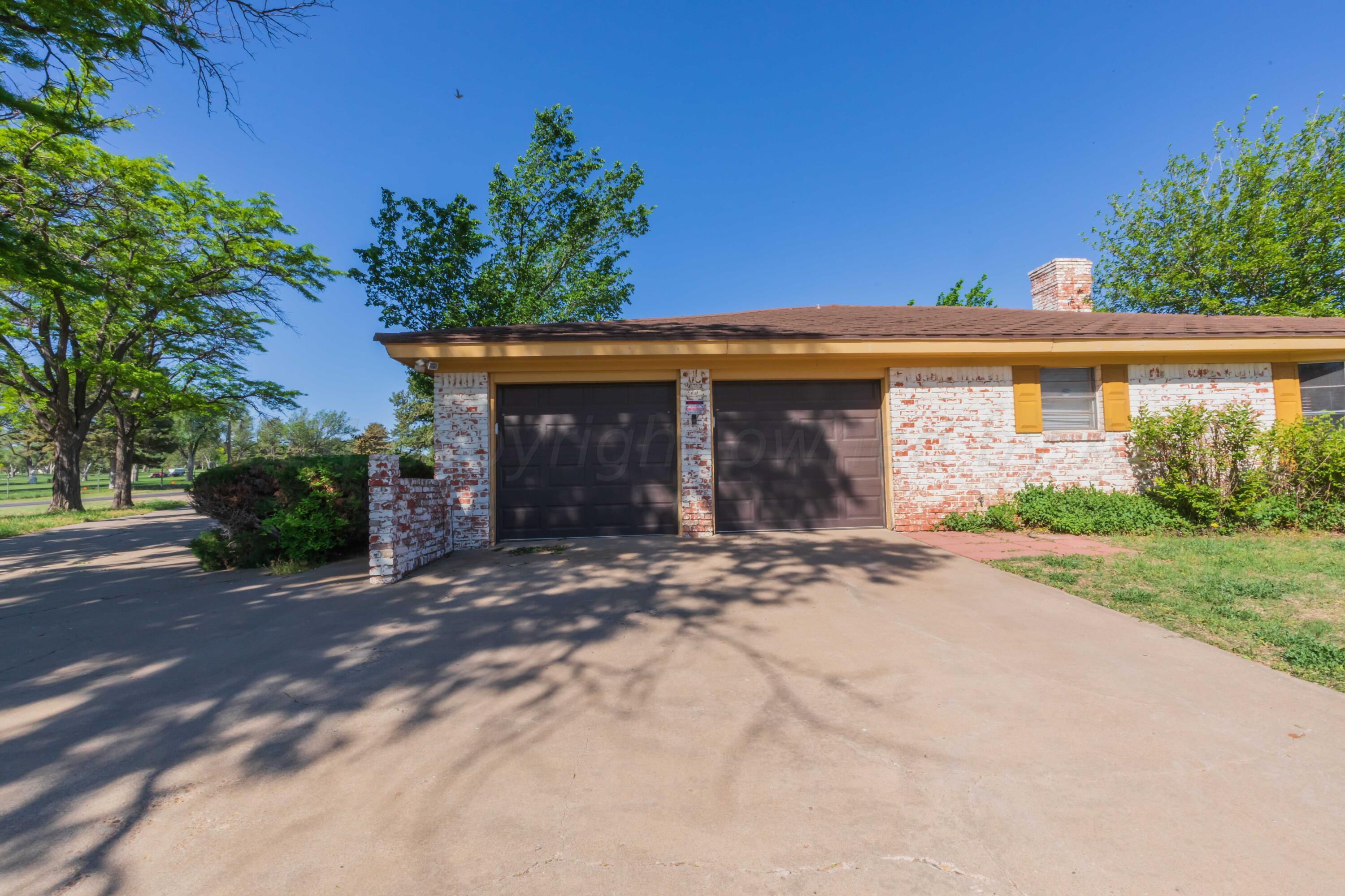 4400 Gem Lake Road Amarillo, TX 79106 - Photo 55 of 57 a front view of a house with a yard and a garage
