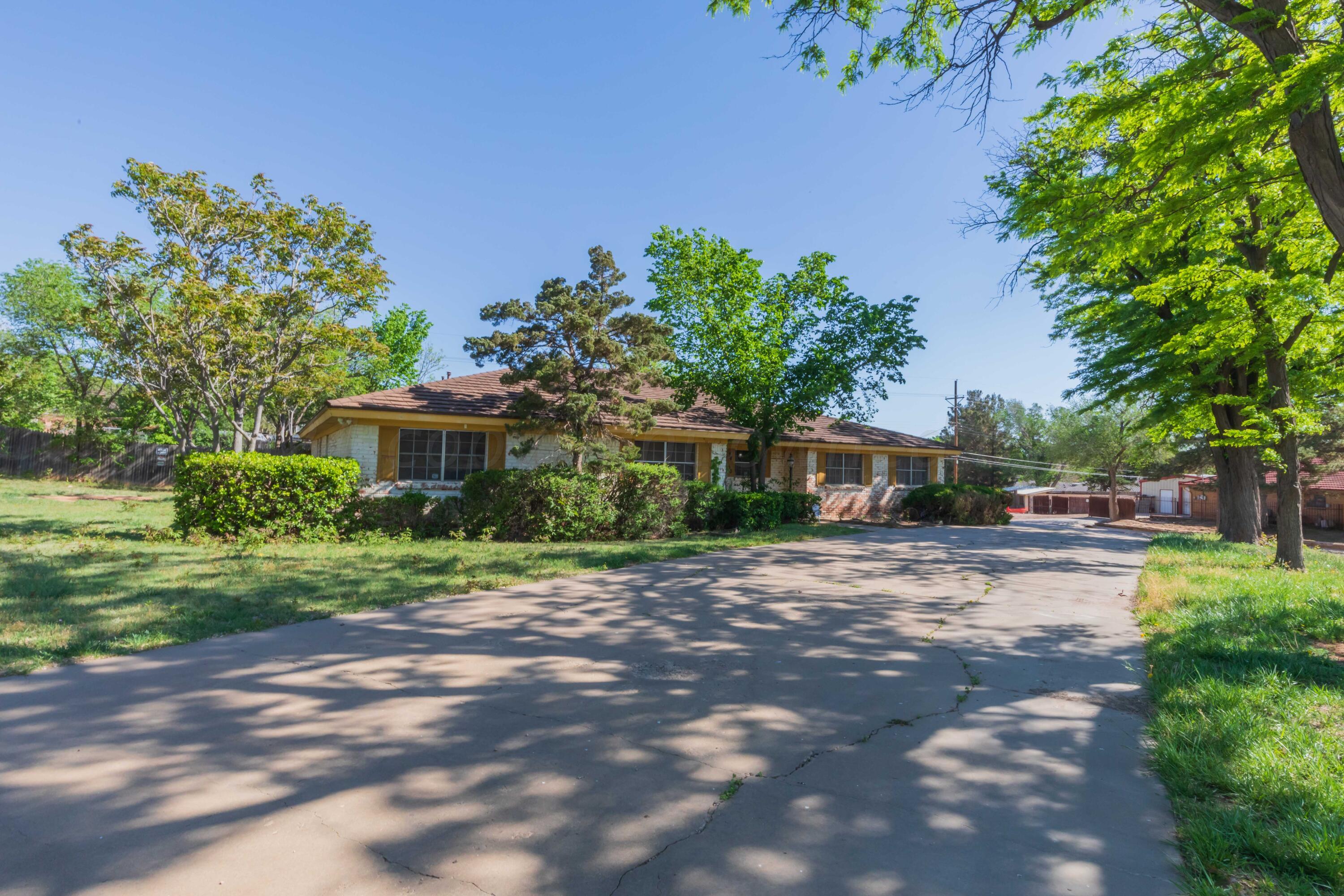 4400 Gem Lake Road Amarillo, TX 79106 - Photo 57 of 57 a front view of a house with a yard and a garden