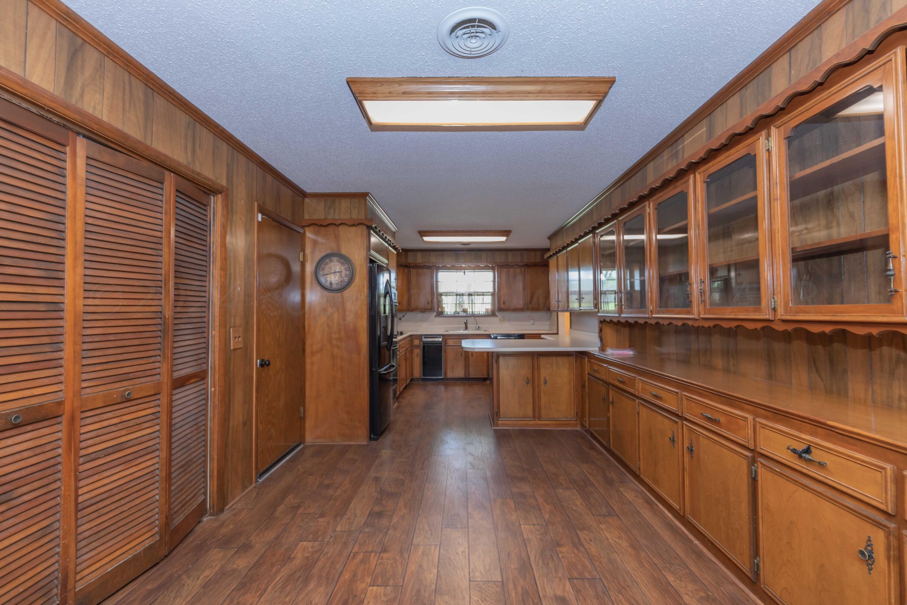 4400 Gem Lake Road Amarillo, TX 79106 - Photo 8 of 57 a kitchen with stainless steel appliances granite countertop a stove and cabinets