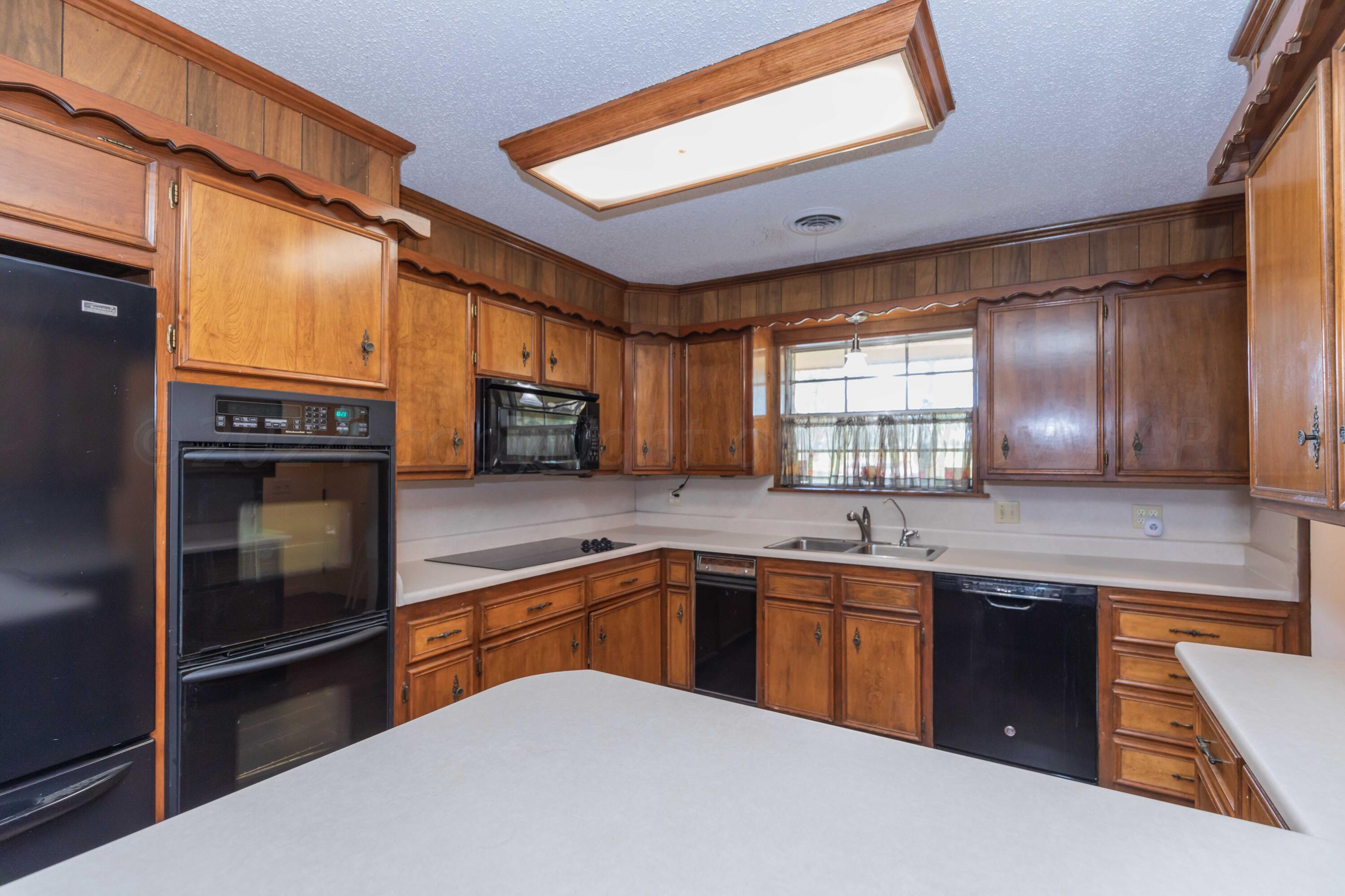 4400 Gem Lake Road Amarillo, TX 79106 - Photo 10 of 57 a kitchen with stainless steel appliances granite countertop a sink a stove and refrigerator
