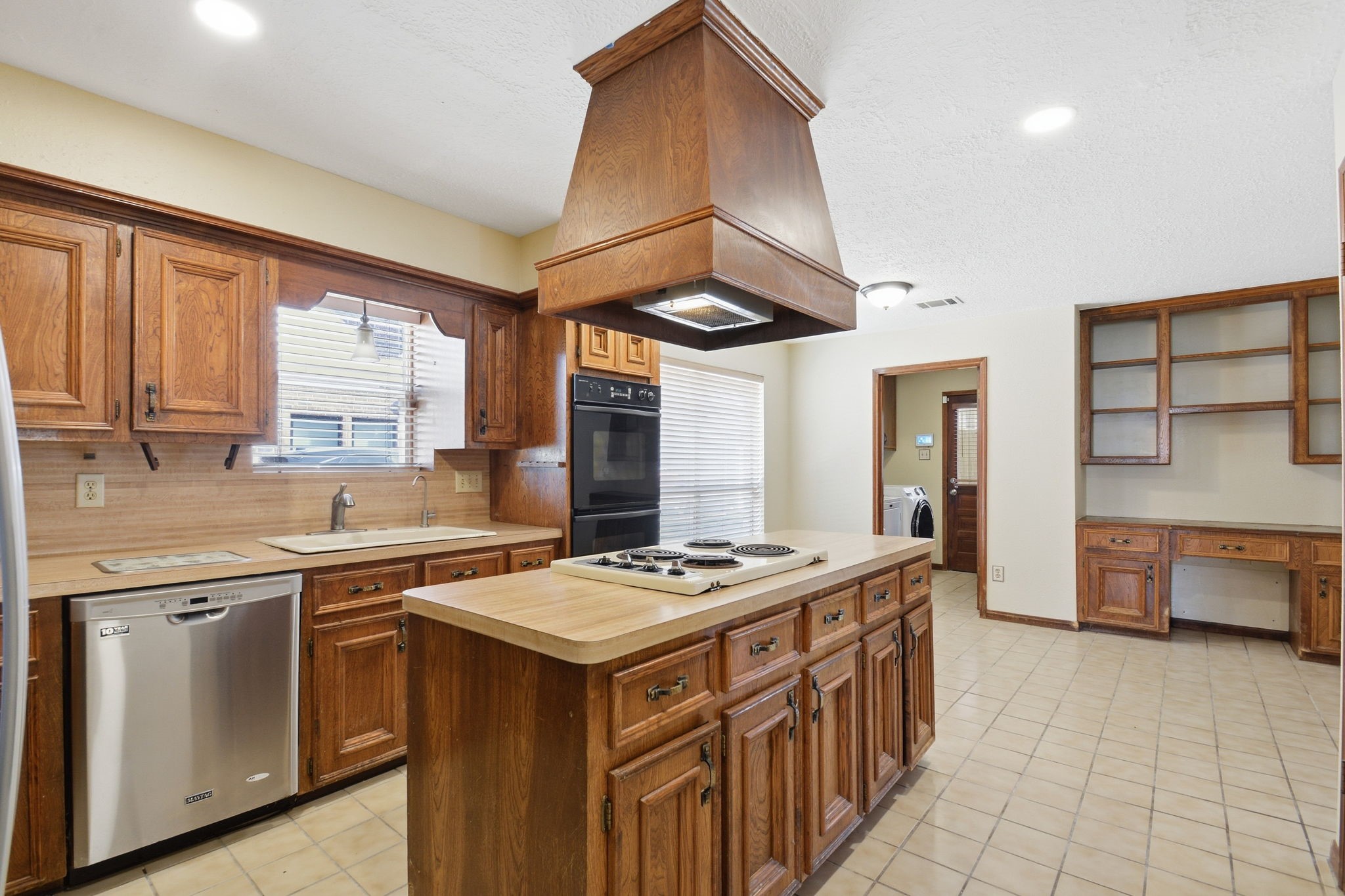 3607 El James Drive Spring, TX 77388 - Photo 19 of 50 This view of the kitchen gives you an idea of how spacious it is! Island, check; window over the sink, check; pantry, check; built in shelving for cookbooks, check; large dining space, check; huge window for natural light, check! So many possibilities with this room...