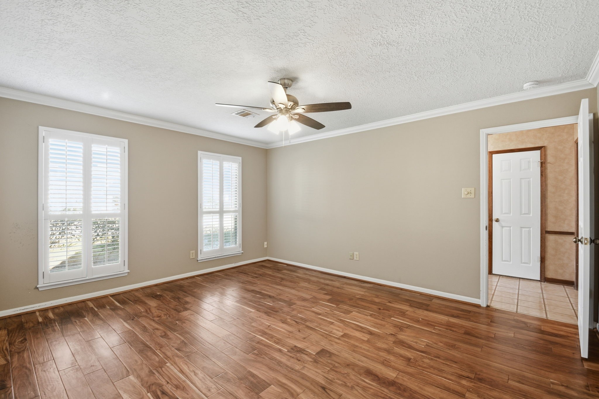 3607 El James Drive Spring, TX 77388 - Photo 22 of 50 View of primary bedroom looking toward the entrance. Note updated wood flooring and Plantation Shutters.