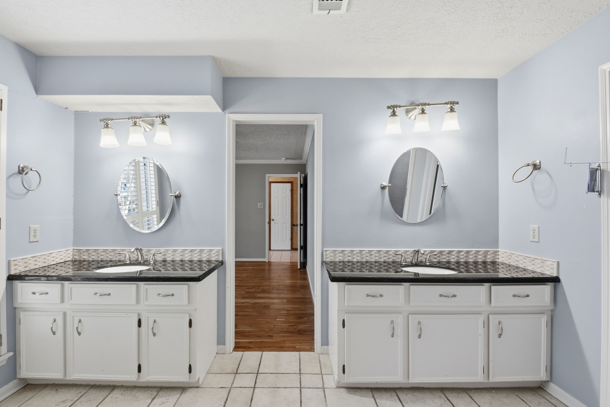 3607 El James Drive Spring, TX 77388 - Photo 26 of 50 Two separate vanities with granite countertops gives each person their own space. Add to that the two walk-in closets, the enclosed shower and a private toilet room, this primary suite is better than couples counseling!