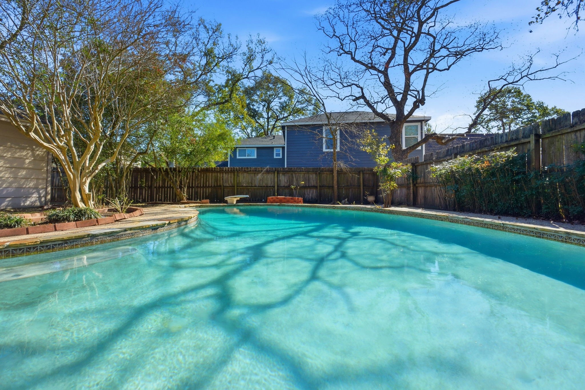 3607 El James Drive Spring, TX 77388 - Photo 42 of 50 View of the pool looking away from the house. The pool has a child safety fence that has been taken down, but is still at the property. There is a large open space behind the garage as well as a little fenced-in area to the right for your pups or a small play area for the the littles.