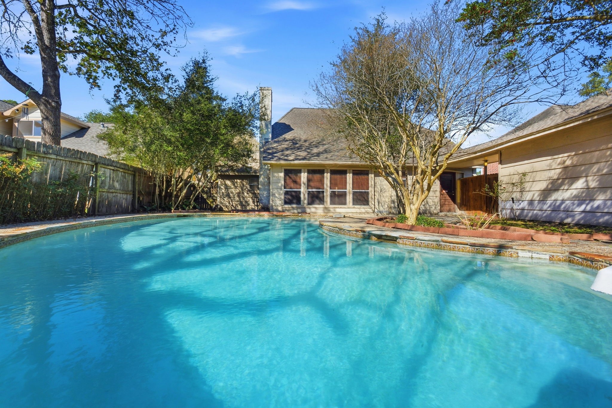 3607 El James Drive Spring, TX 77388 - Photo 43 of 50 View of the pool from the deep end looking toward the house. You can kind of see to the left of the house where there is a little fenced-in area to the right for your pups or a small play area for the littles.