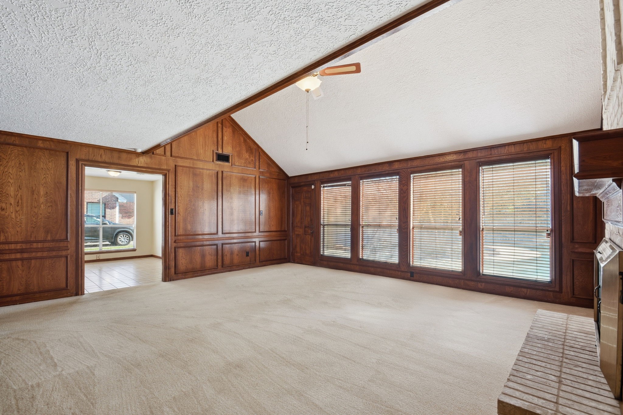 3607 El James Drive Spring, TX 77388 - Photo 10 of 50 Another angle of the large living room, this one showing the wall of windows overlooking the pool as well as the open kitchen/dining area in the background.