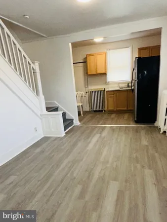 a view of a bedroom with wooden floor and stairs